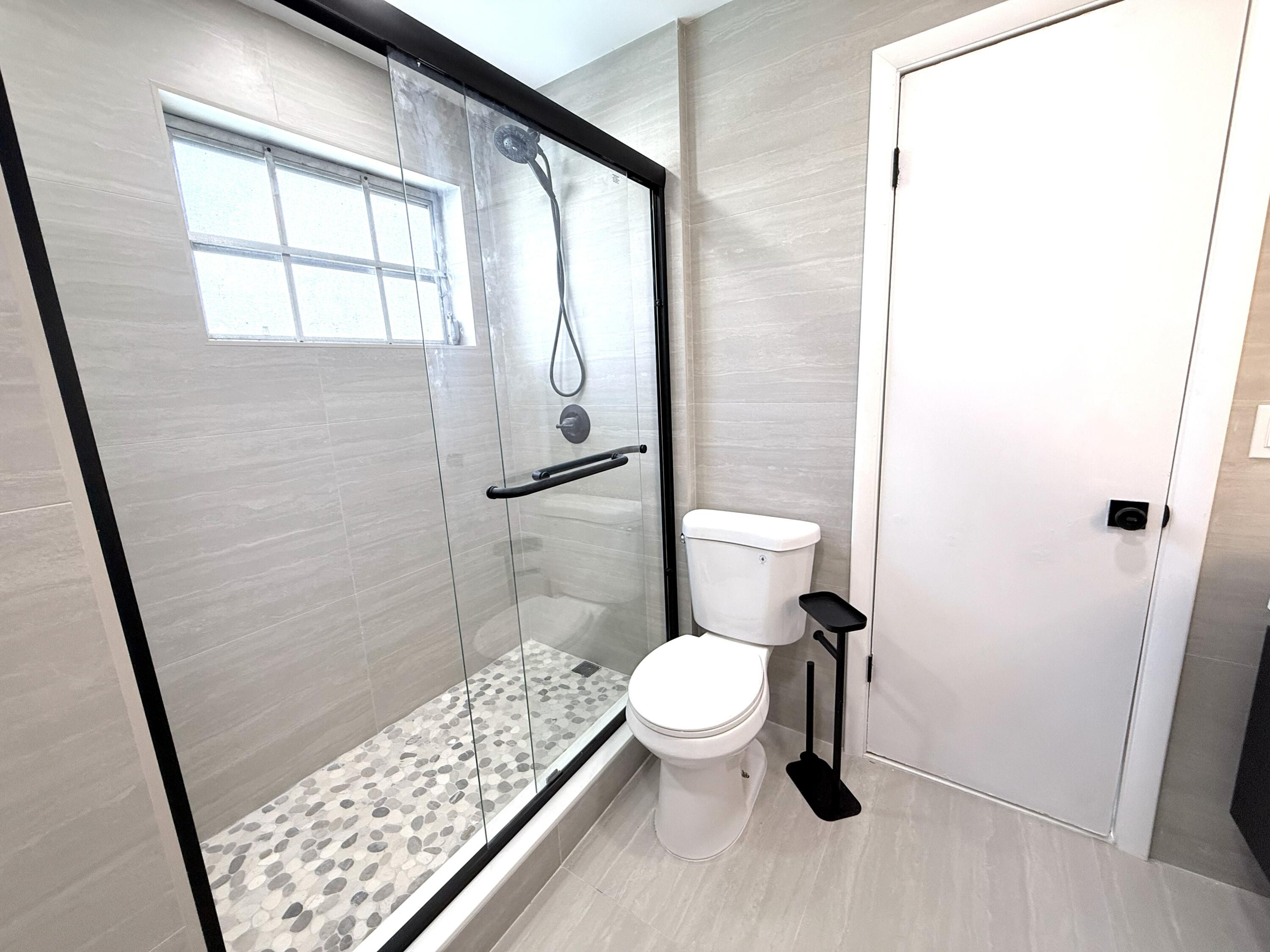 210 West 23rd Street Riviera Beach, FL 33404 - Photo 12 of 20 a white toilet sitting next to a bathroom sink