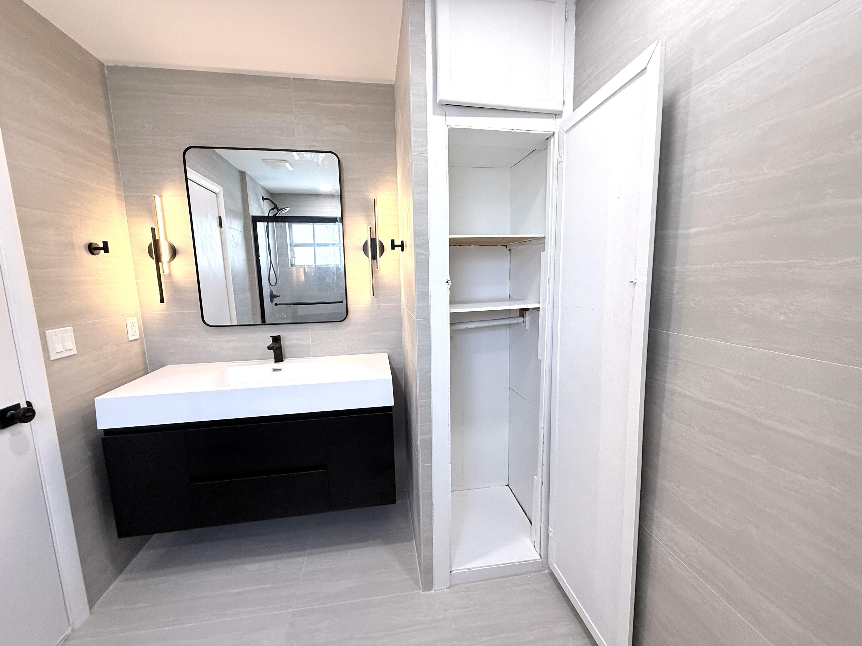 210 West 23rd Street Riviera Beach, FL 33404 - Photo 18 of 20 a bathroom with a sink a toilet and mirror