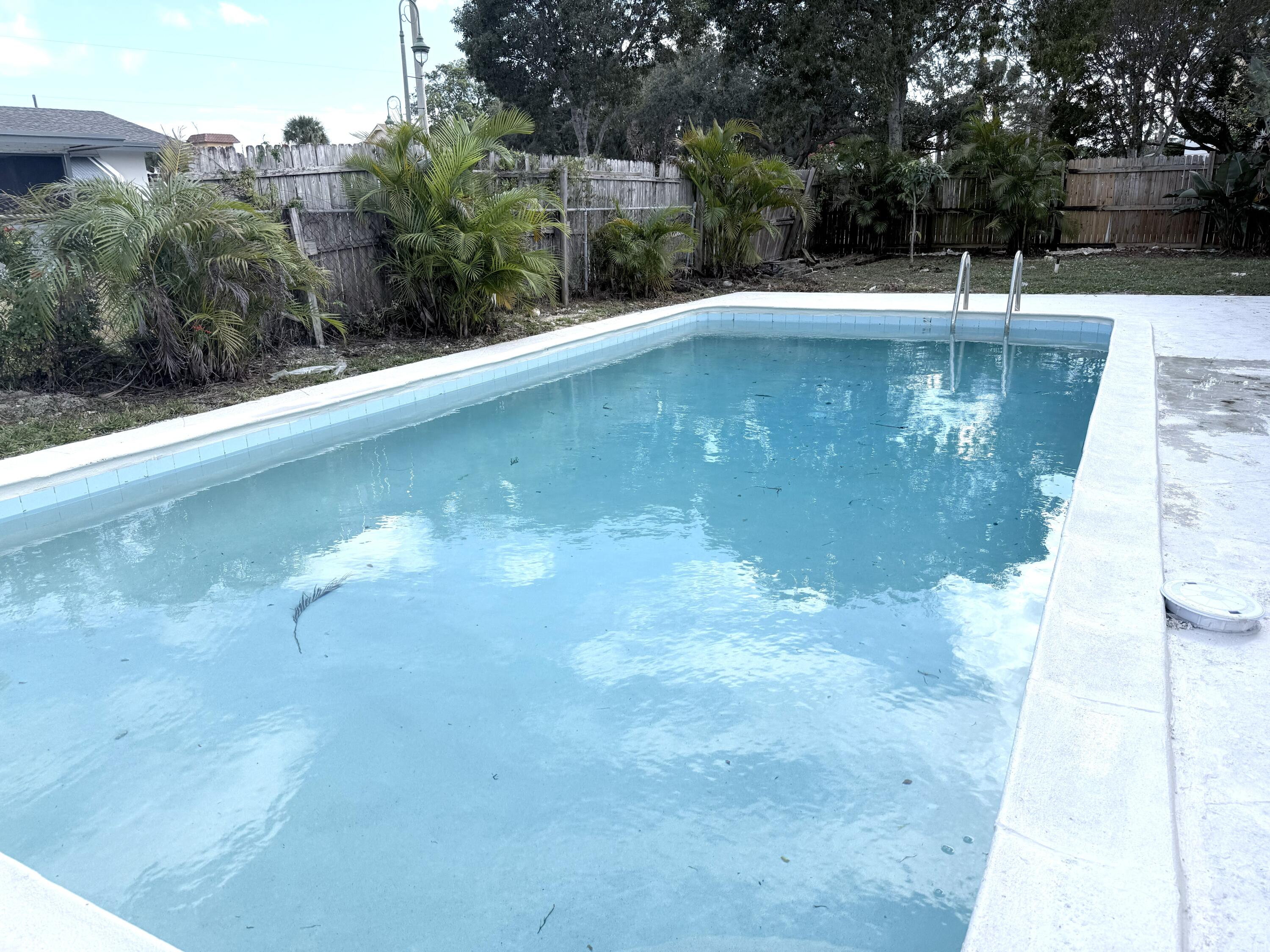210 West 23rd Street Riviera Beach, FL 33404 - Photo 2 of 20 a view of a swimming pool with an outdoor space