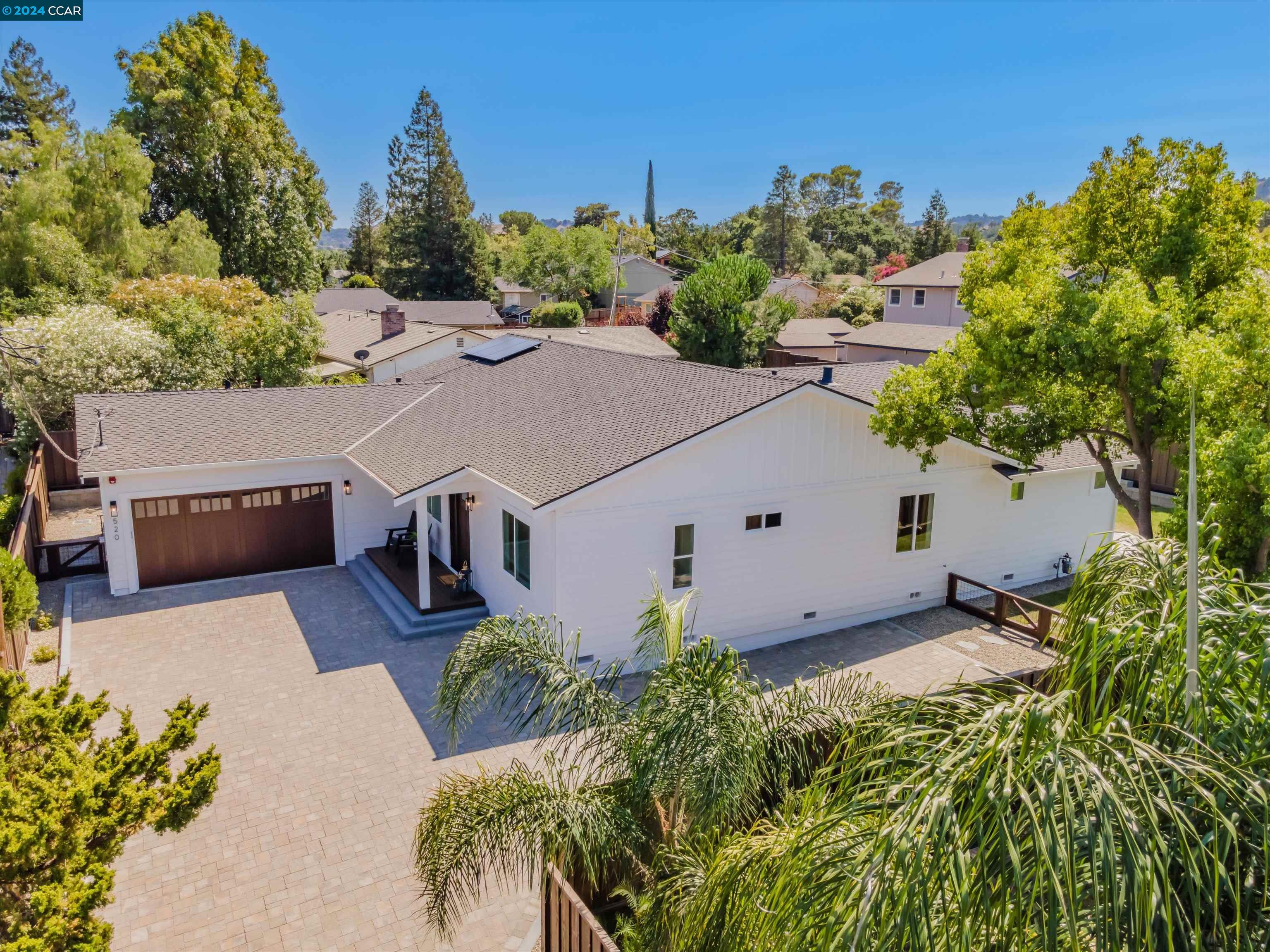 an aerial view of a house with yard and outdoor seating