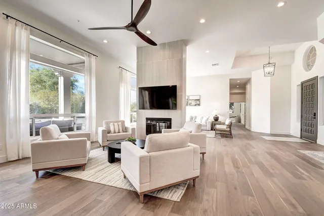 a kitchen with stainless steel appliances granite countertop a refrigerator a stove and a sink with wooden floor