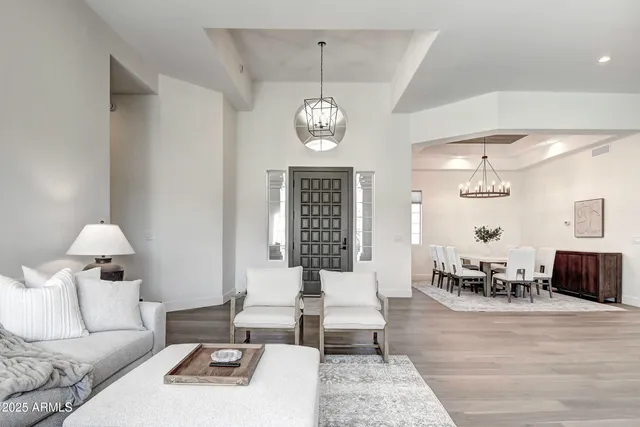 a living room with furniture chandelier and window