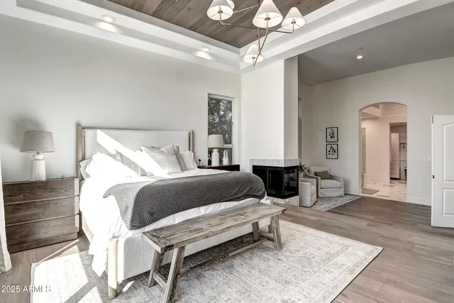 a bedroom with a bed and a painting on the wall