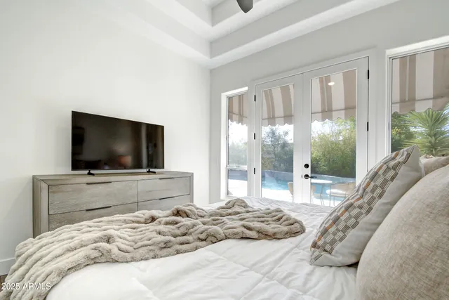 a view of a patio with table and chairs potted plants and large tree
