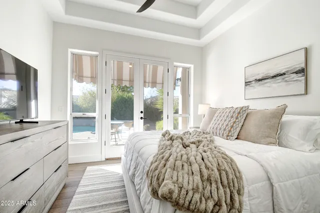 a living room with furniture a rug and white walls