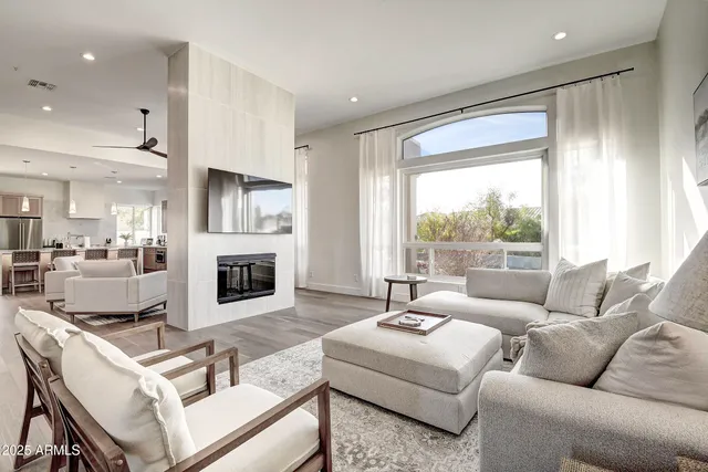 a living room with furniture a fireplace and a flat screen tv