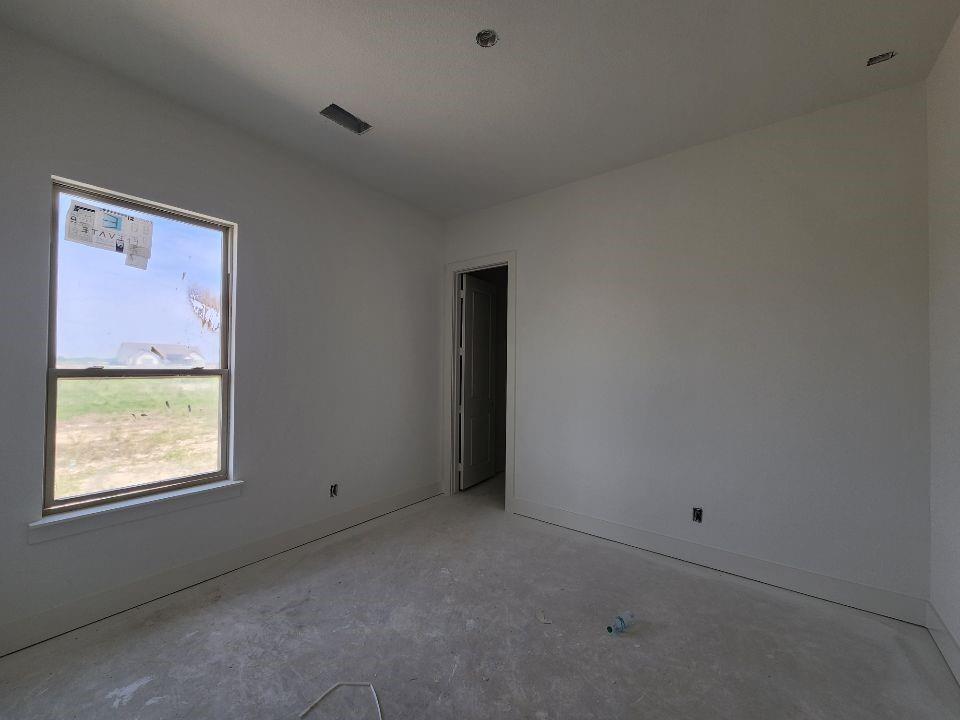 2408 Quartz Street Krum, TX 76249 - Photo 7 of 13 an empty room with a window