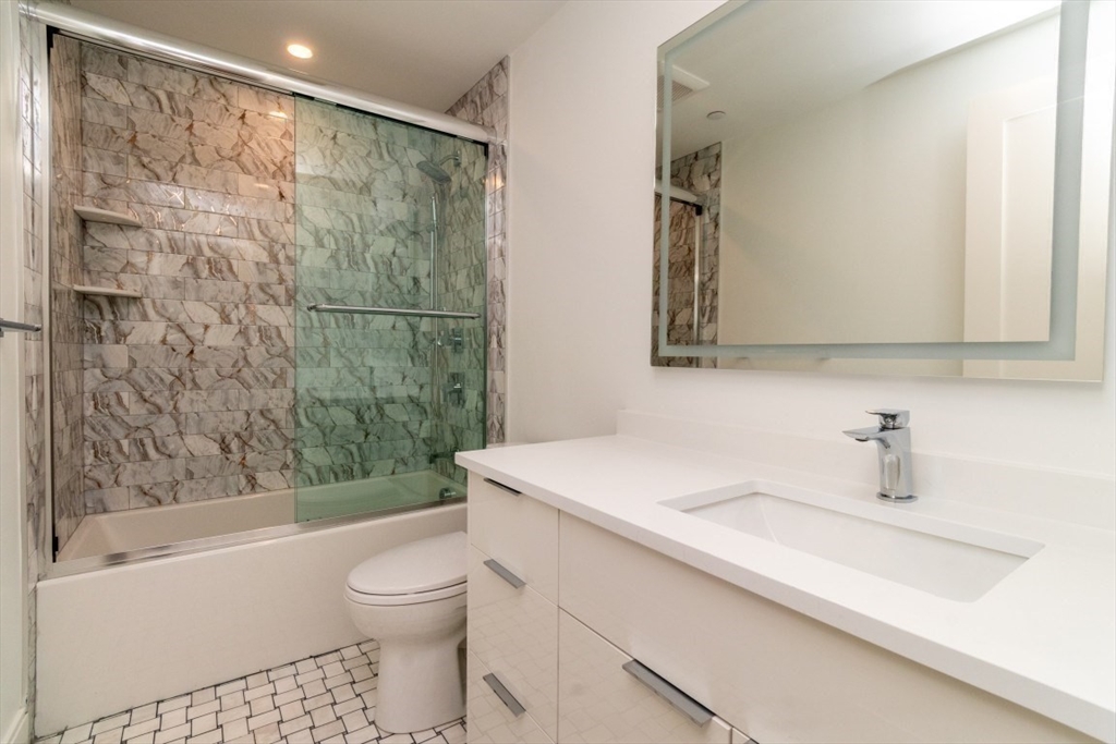 15 Tanglewood Road, Unit A Boston, MA 02126 - Photo 19 of 28 a bathroom with a sink a toilet and a bathtub