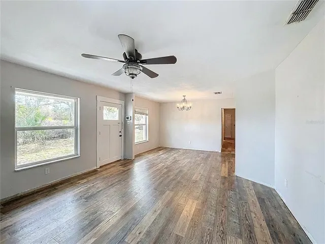 an empty room with windows and entrance