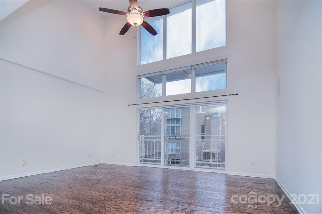 610 Raphael Place Charlotte, NC 28205 - Photo 13 of 27 an empty room with wooden floor and windows