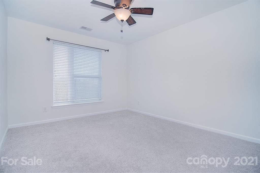 610 Raphael Place Charlotte, NC 28205 - Photo 23 of 27 an empty room with a window and a fan