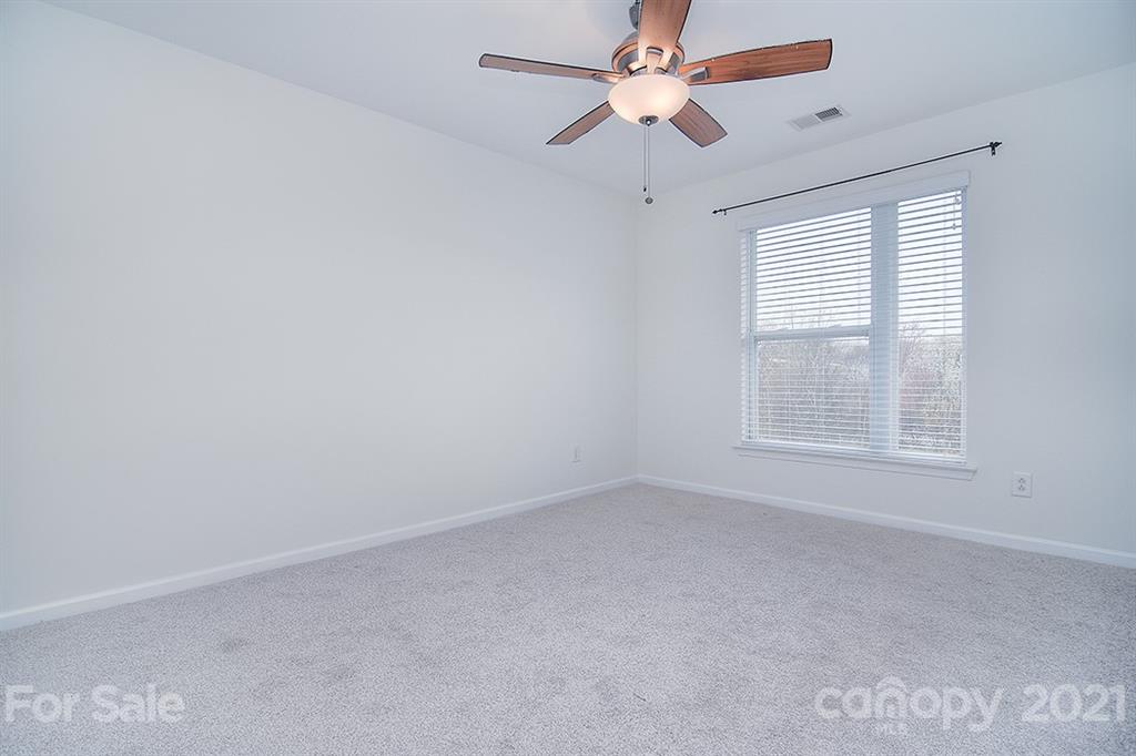 610 Raphael Place Charlotte, NC 28205 - Photo 25 of 27 an empty room with a window and a fan