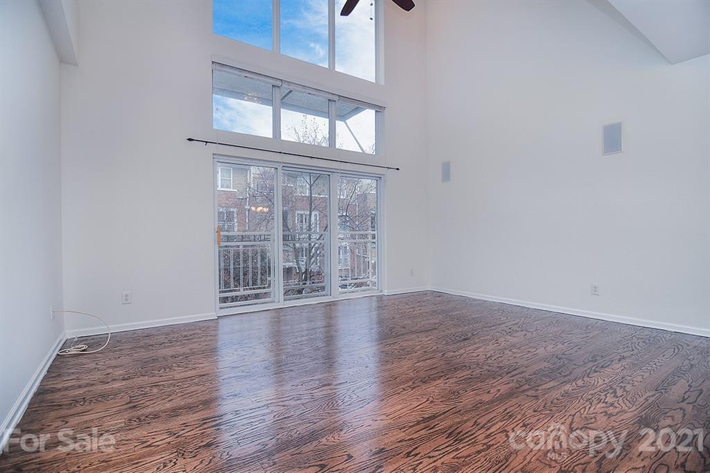 610 Raphael Place Charlotte, NC 28205 - Photo 4 of 27 a view of an empty room with wooden floor and a window