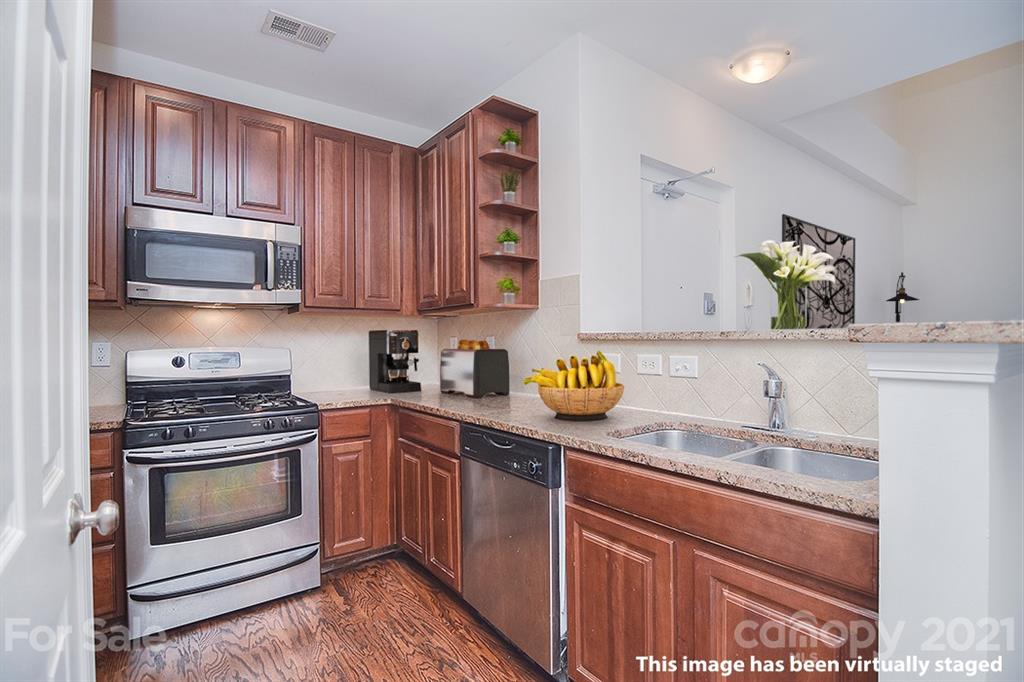 610 Raphael Place Charlotte, NC 28205 - Photo 5 of 27 a kitchen with granite countertop a stove sink and microwave