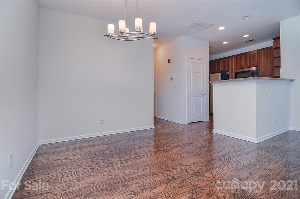 610 Raphael Place Charlotte, NC 28205 - Photo 9 of 27 a view of a kitchen with a sink and wooden cabinets