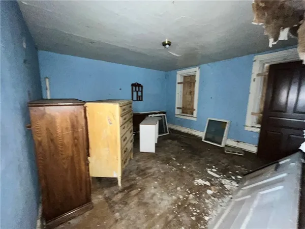 a bed room with a bed and a refrigerator