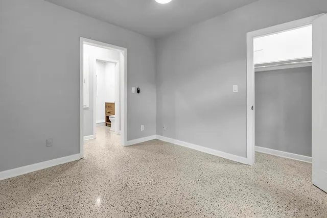 an empty room with closet area