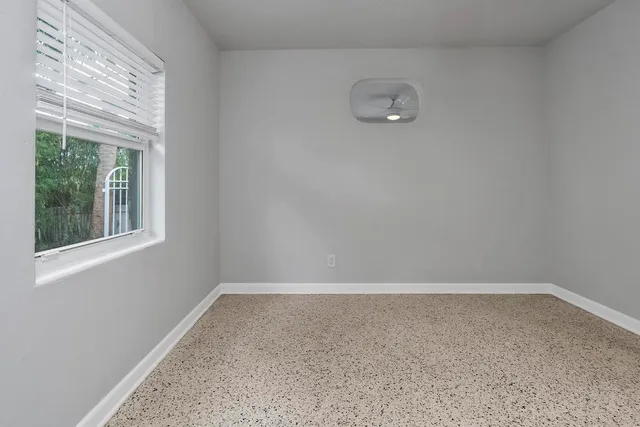 a view of an empty room with a window