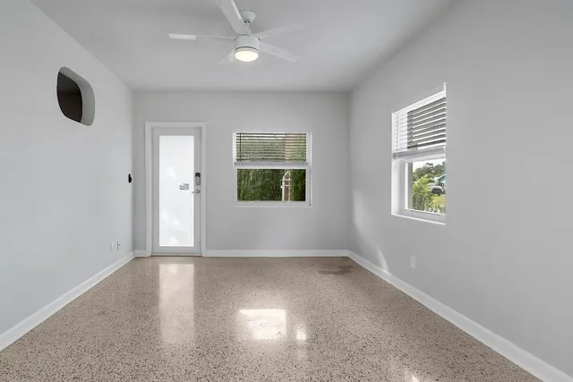 an empty room with windows and closet