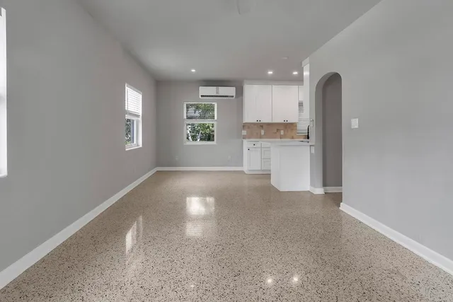 a view of a kitchen with a sink and dishwasher a stove top oven with white cabinets