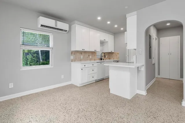 a kitchen with a sink stove and cabinets
