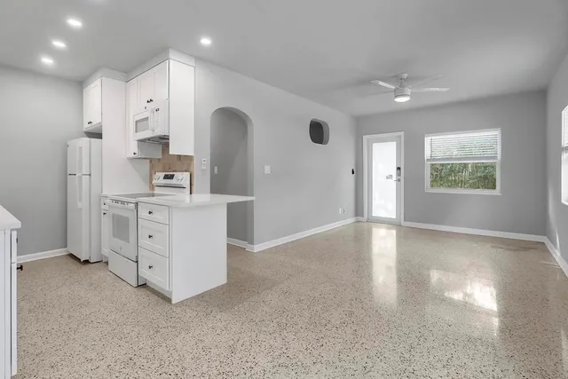a view of a kitchen with electric appliances