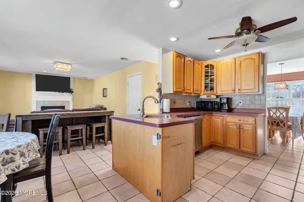 a living room with furniture a dining table and a stove top oven