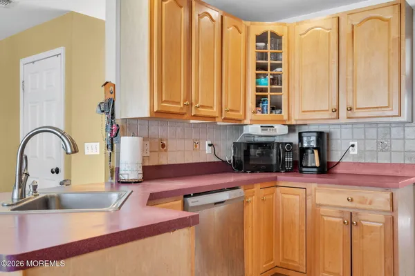 a kitchen with stainless steel appliances granite countertop a sink a stove and cabinets