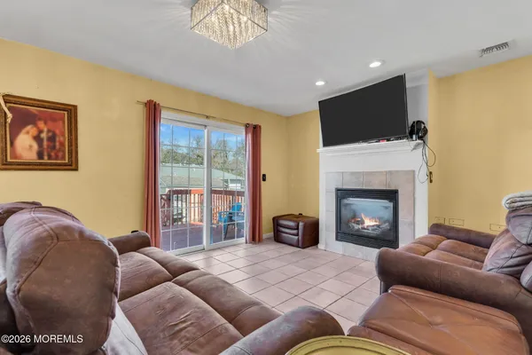 a living room with furniture a flat screen tv and a fireplace
