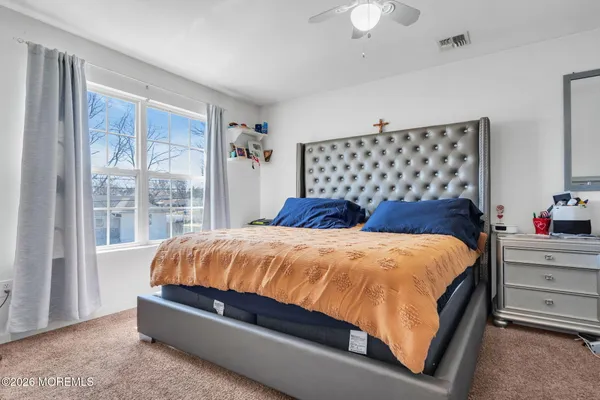 a bed sitting in a bedroom next to a window