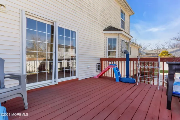 a view of a house with wooden deck and furniture