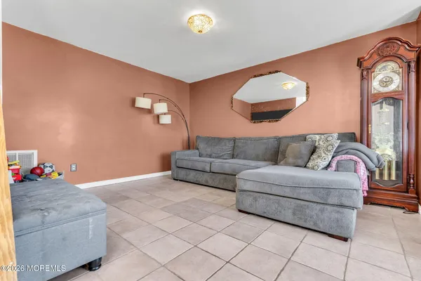 a living room with furniture and a mirror
