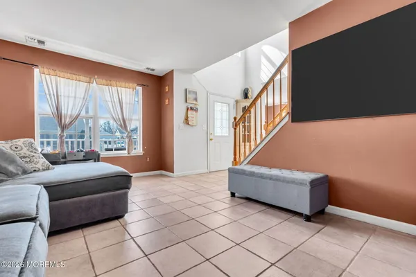 a living room with furniture and a large window