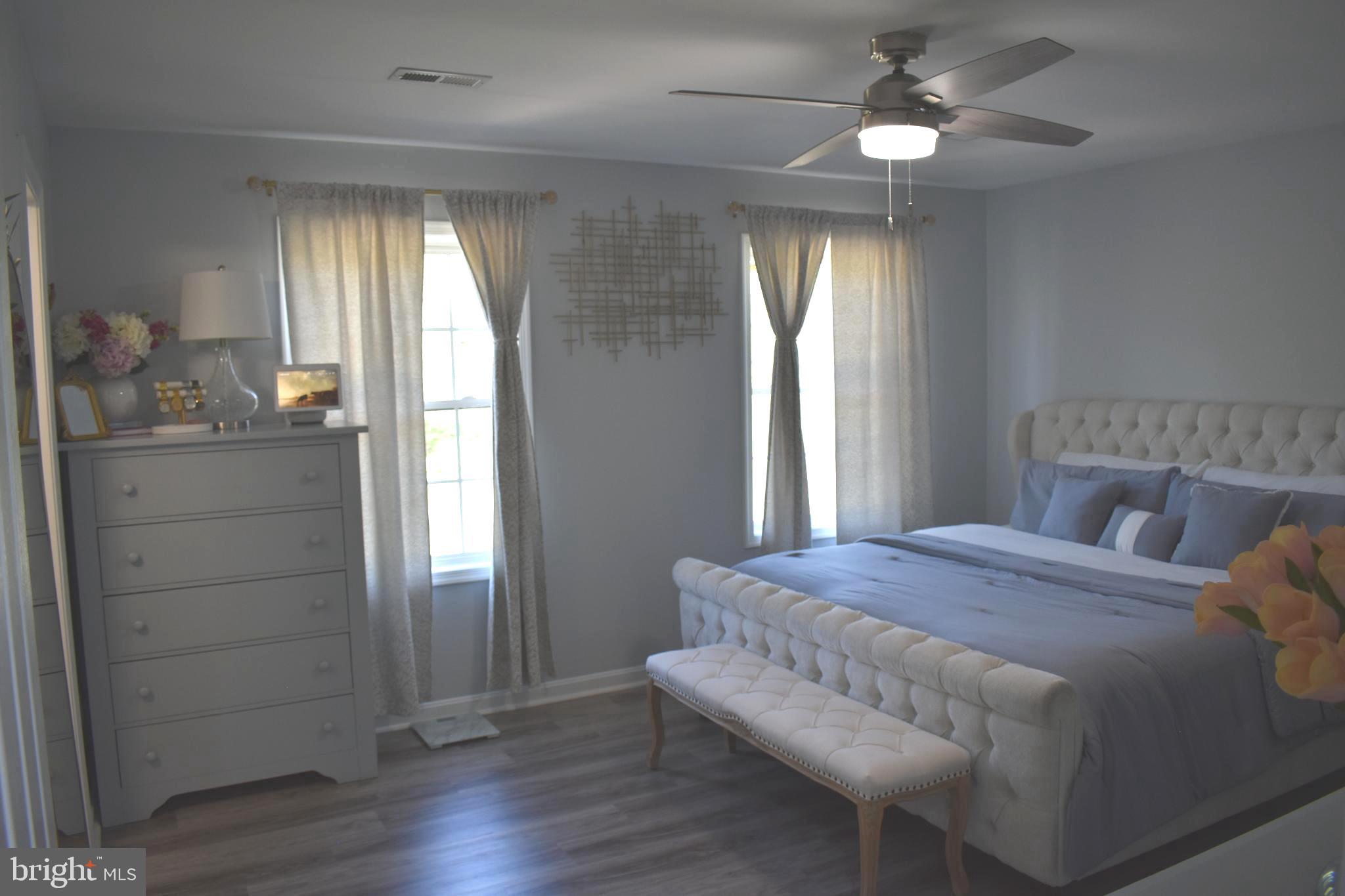 10958 Mountain Run Lake Road Culpeper, VA 22701 - Photo 16 of 31 a bedroom with a bed and a chandelier