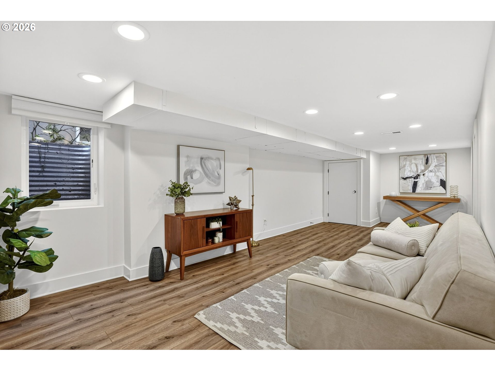 3923 Northeast 76th Avenue Portland, OR 97213 - Photo 32 of 48 a living room with furniture a wooden floor and a fireplace
