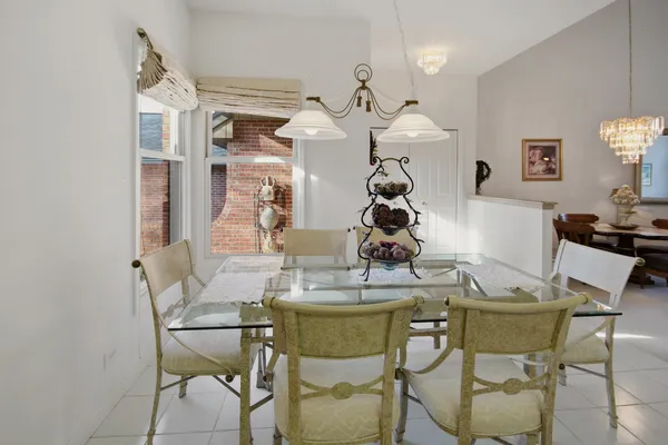 a dining room table chairs and a chandelier