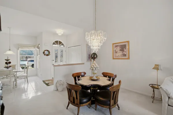 a view of a dining room with furniture and chandelier