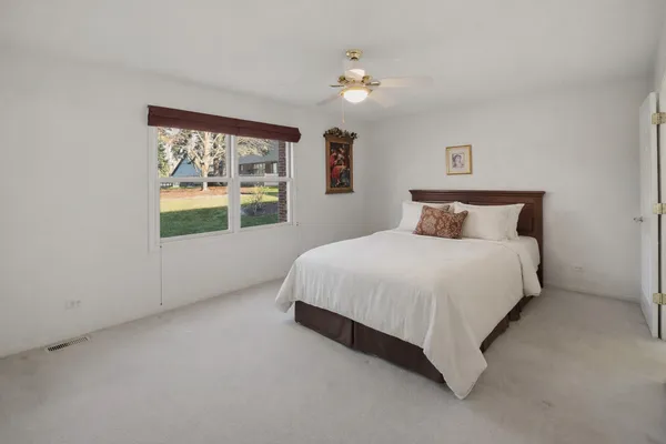 a bedroom with a large bed and a window