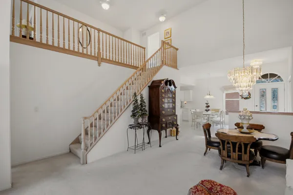 a dining room with furniture entryway and a chandelier