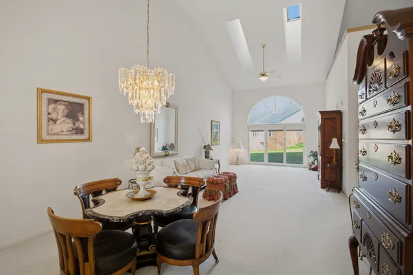 a view of a a dining room with furniture window and wooden floor