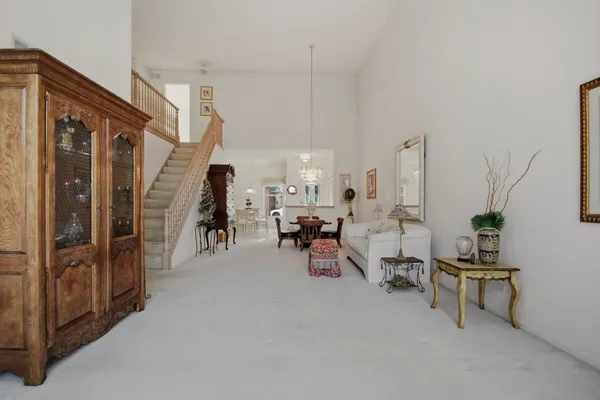 a living room with lots of furniture and a chandelier