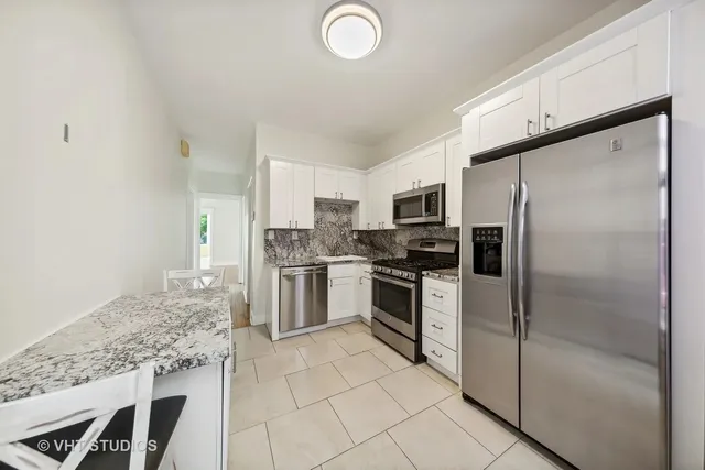 a kitchen with a refrigerator sink and microwave