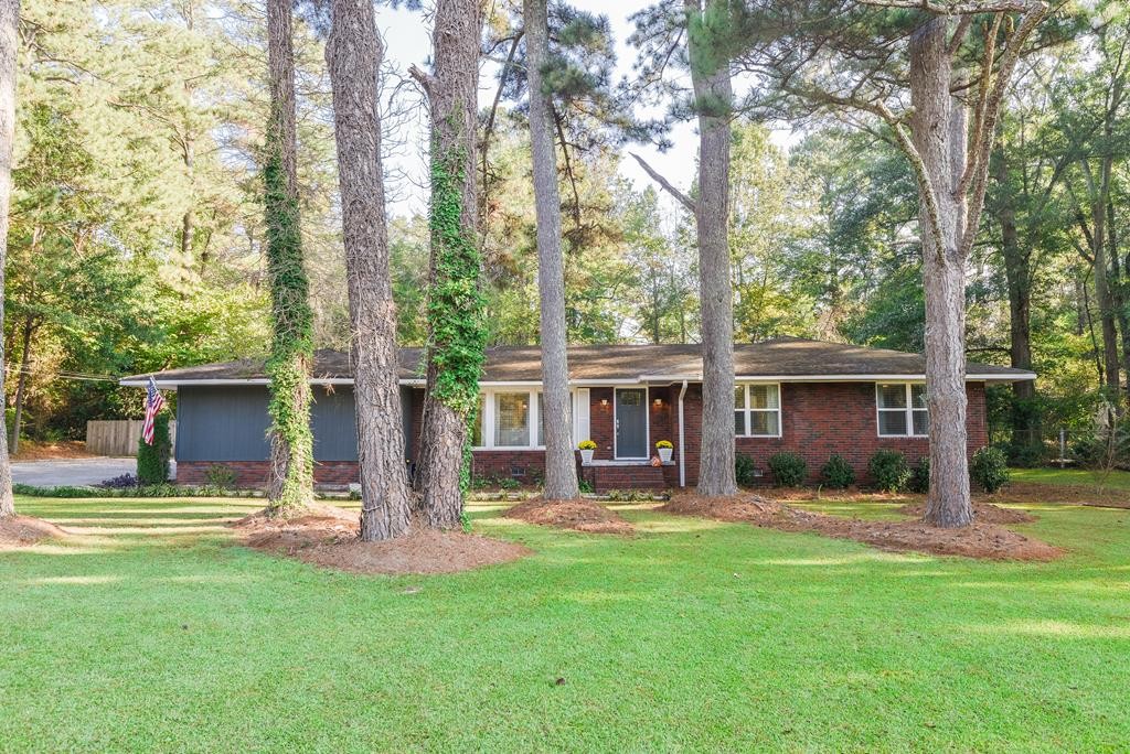 a view of a house with a yard porch and sitting area