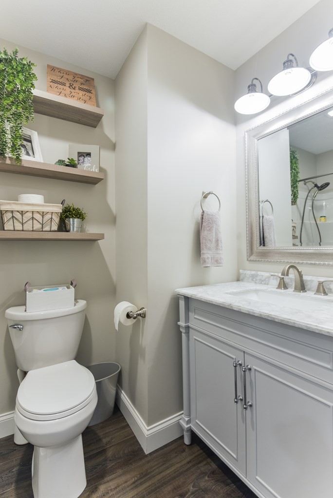 3741 Airport Road Southeast Dalton, GA 30721 - Photo 53 of 70 a bathroom with a toilet a sink and wooden floor