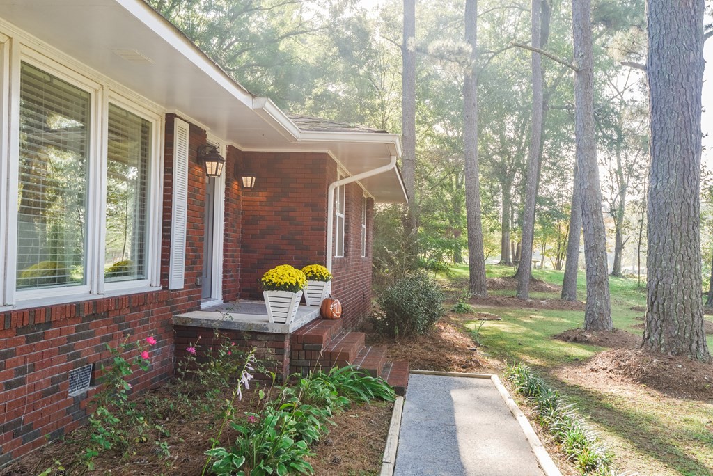 3741 Airport Road Southeast Dalton, GA 30721 - Photo 8 of 70 a front view of a house with a garden and outdoor seating