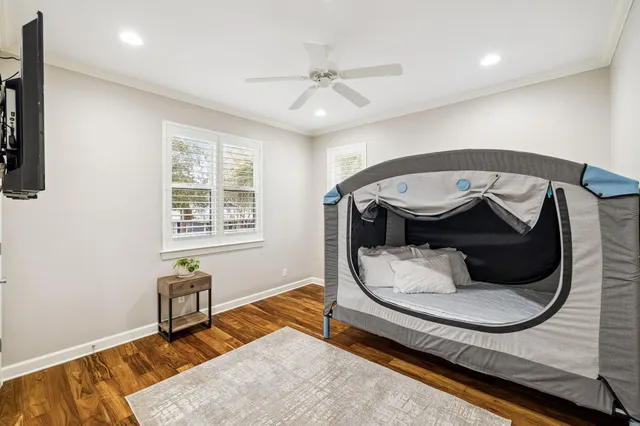a bedroom with a bed and wooden floor