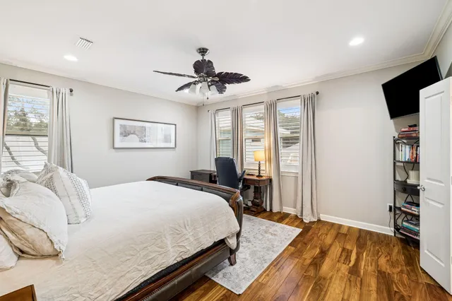 a bedroom with a bed a table and chair