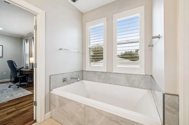 a utility room with stainless steel appliances granite countertop a stove and a refrigerator