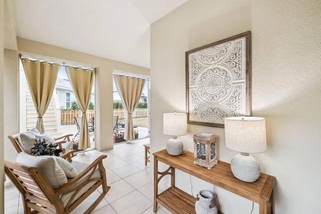 a living room with large windows and furniture