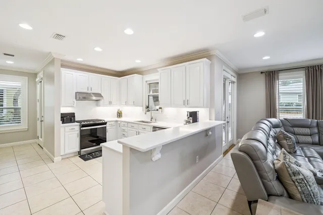 a kitchen with a sink a stove a refrigerator and cabinets